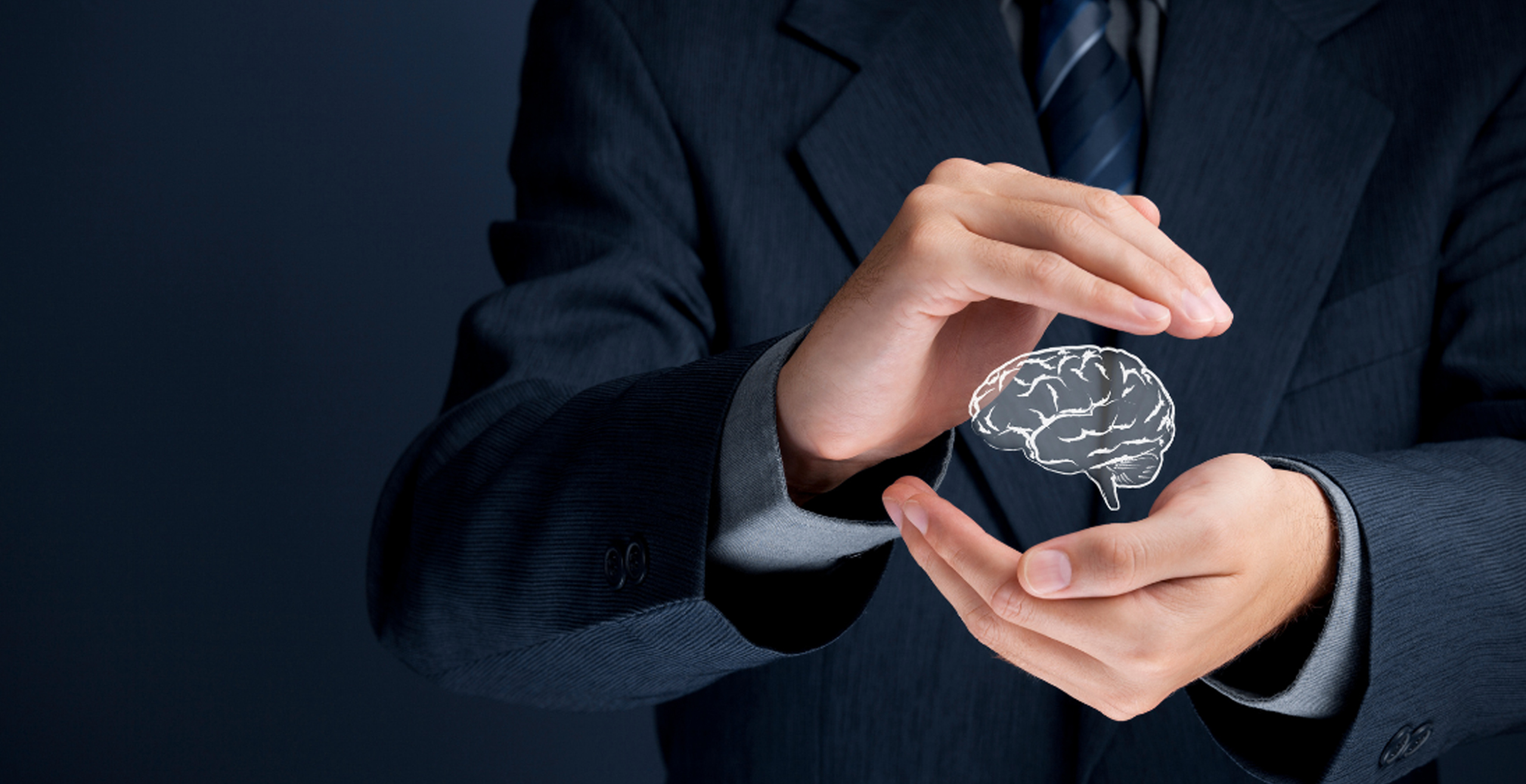 Hands holding an image representing ideas that result in trademarks and patents.